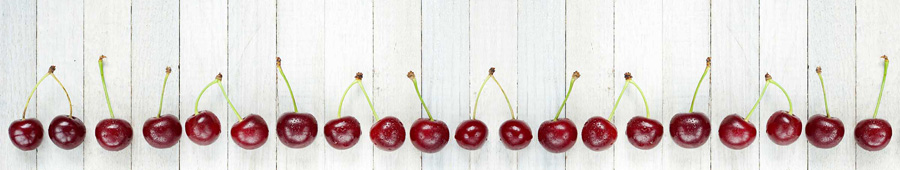 Скинали для кухни: Ряд из ягод вишни на белом столе